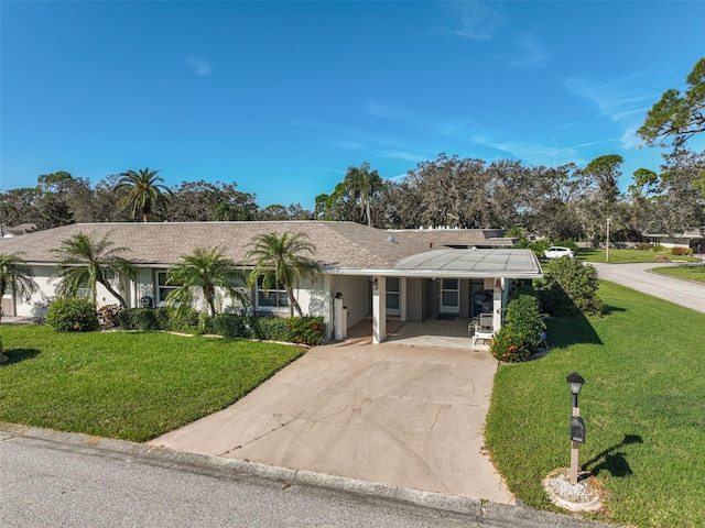 1402 Grand Blvd Unit 240, Sarasota, FL 34232 - single story home featuring concrete driveway, a front yard, a carport, and covered porch