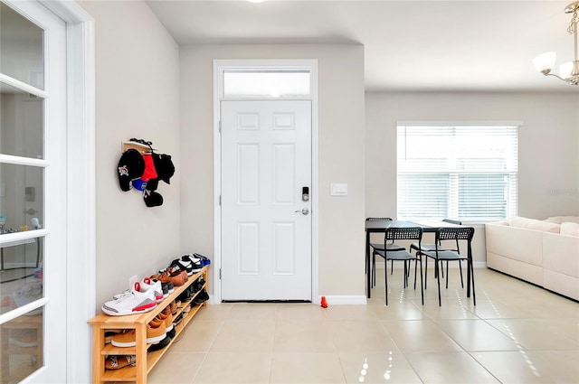 entrance foyer featuring a chandelier and light tile patterned floors