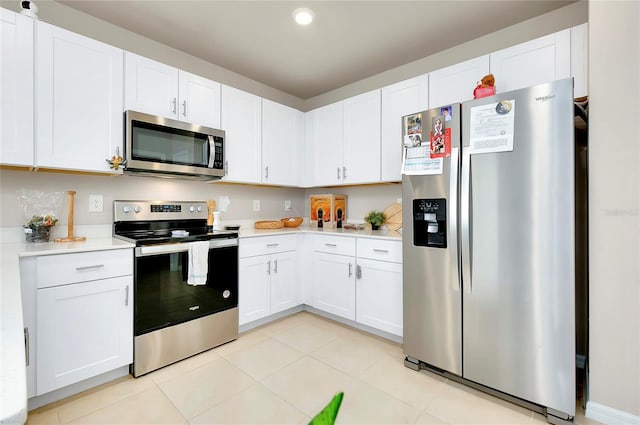 kitchen with appliances with stainless steel finishes and white cabinets