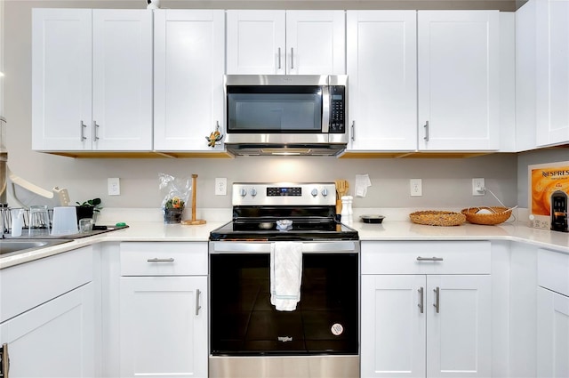 kitchen with appliances with stainless steel finishes and white cabinets