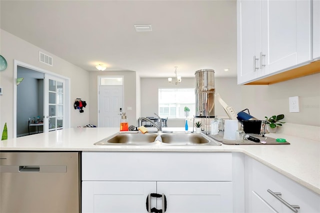 kitchen featuring kitchen peninsula, dishwasher, white cabinets, and sink