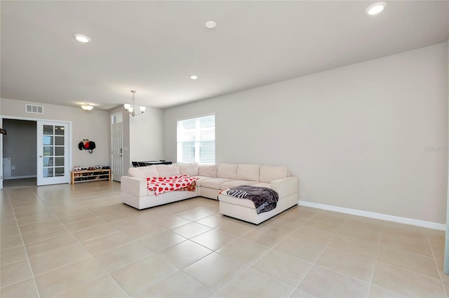 tiled living room featuring a chandelier