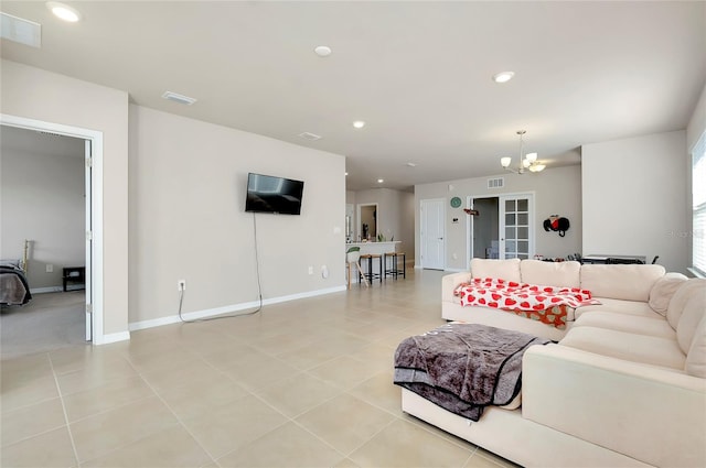 tiled living room featuring an inviting chandelier