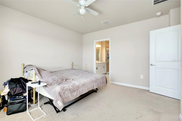 bedroom featuring ensuite bathroom, carpet floors, and ceiling fan