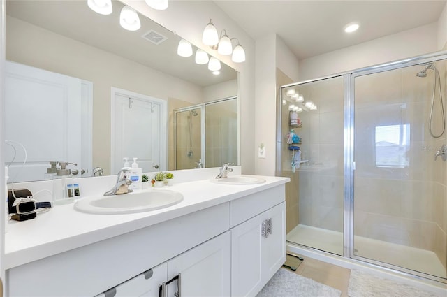 bathroom with vanity, tile patterned floors, and walk in shower