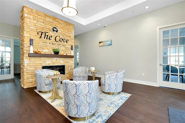 sitting room featuring dark wood-type flooring and a fireplace