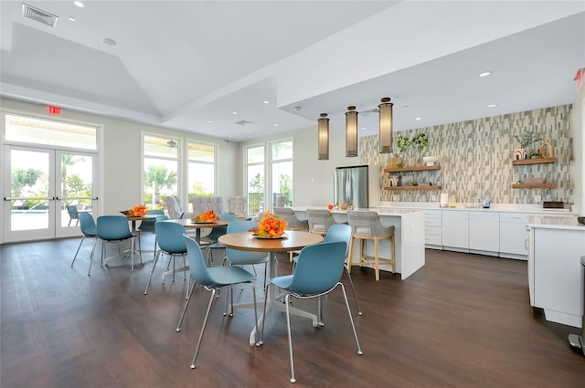 dining room with french doors, dark hardwood / wood-style floors, and vaulted ceiling