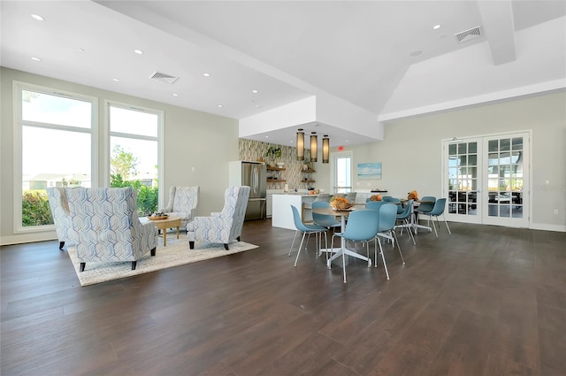 dining room featuring lofted ceiling, dark hardwood / wood-style floors, and a wealth of natural light