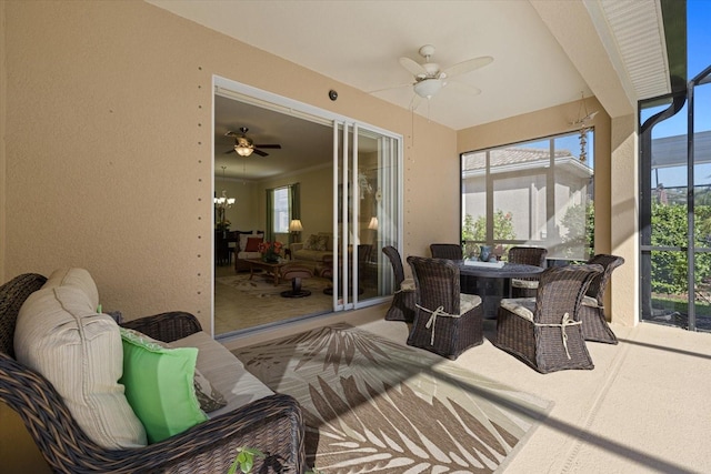 sunroom / solarium featuring ceiling fan