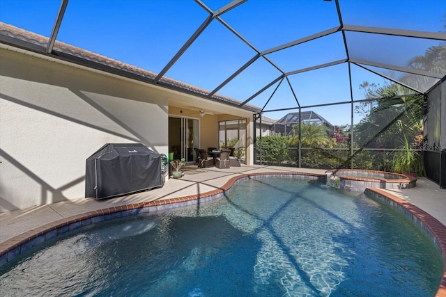 view of pool with an in ground hot tub, area for grilling, a patio area, glass enclosure, and ceiling fan