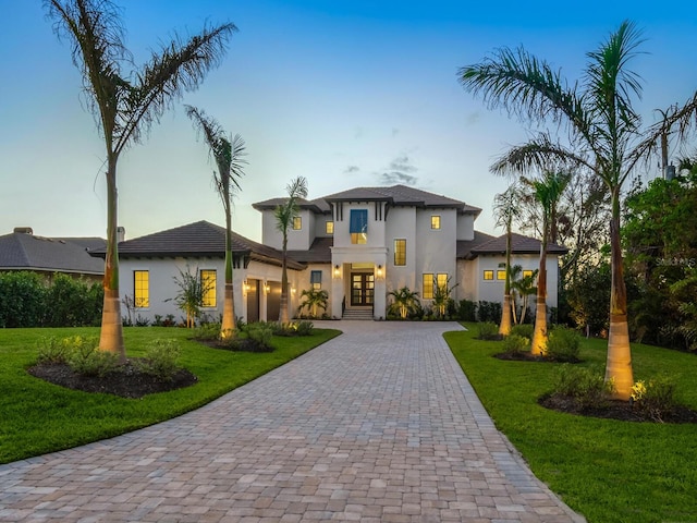 view of front of property featuring french doors and a front lawn