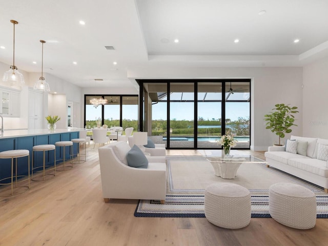 living room with light hardwood / wood-style flooring and a healthy amount of sunlight