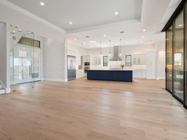 unfurnished living room featuring light hardwood / wood-style flooring and sink