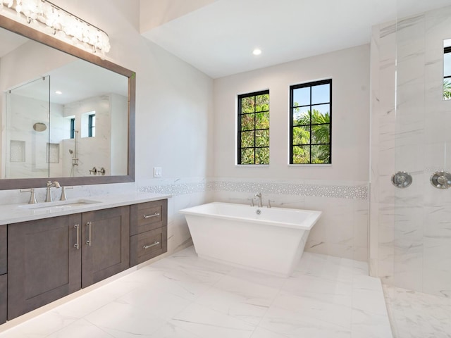 bathroom featuring vanity, shower with separate bathtub, and tile walls