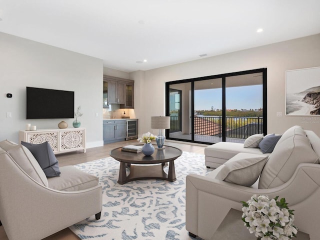 living room featuring wine cooler and light wood-type flooring