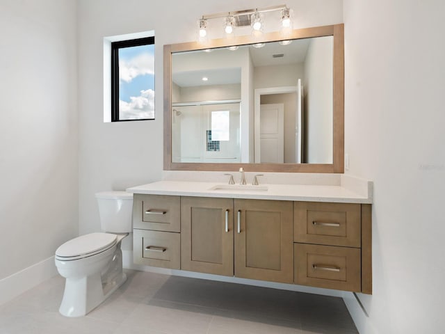 bathroom with tile patterned flooring, vanity, an enclosed shower, and toilet