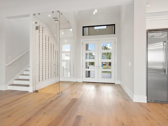 entrance foyer featuring french doors and light hardwood / wood-style floors