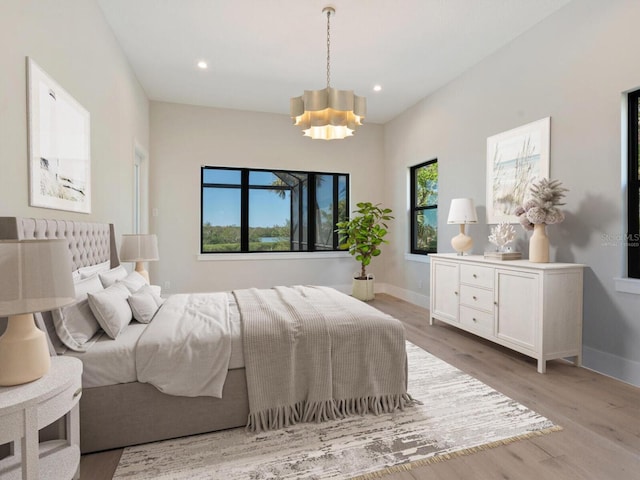 bedroom featuring light hardwood / wood-style floors and an inviting chandelier