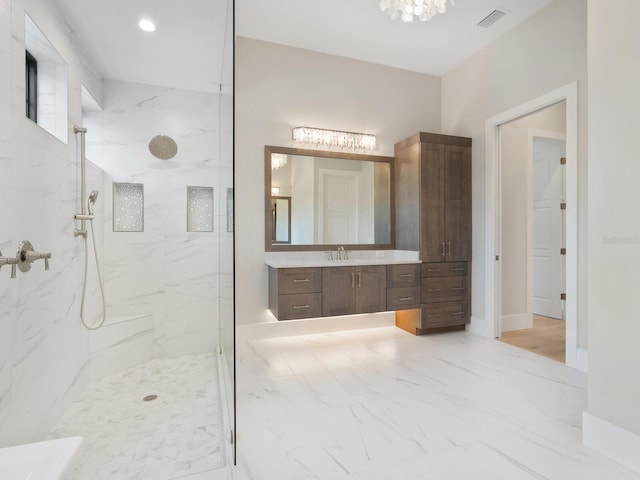 bathroom featuring a tile shower and vanity