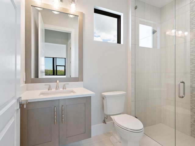 bathroom with an enclosed shower, vanity, toilet, and a wealth of natural light