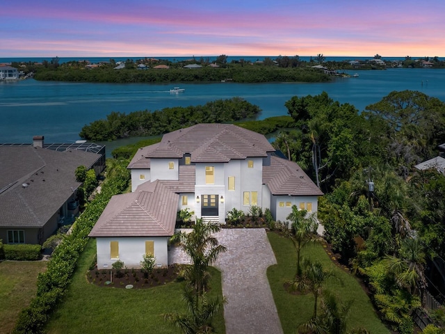 aerial view at dusk with a water view