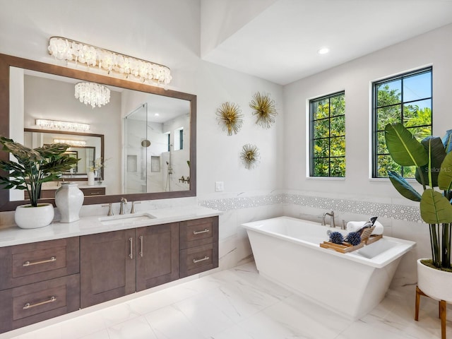 1109 Bayshore Rd, Nokomis, FL 34275 - full bathroom featuring vanity, a freestanding bath, a shower with shower door, a wainscoted wall, and marble finish flooring