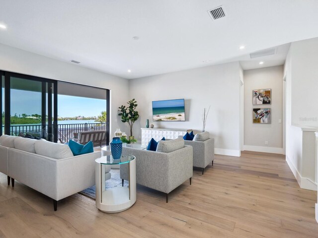 1109 Bayshore Rd, Nokomis, FL 34275 - living area featuring light wood-type flooring, baseboards, and recessed lighting