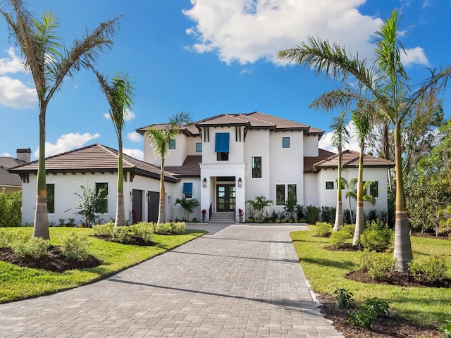 1109 Bayshore Rd, Nokomis, FL 34275 - view of front of property with french doors, stucco siding, decorative driveway, and a garage