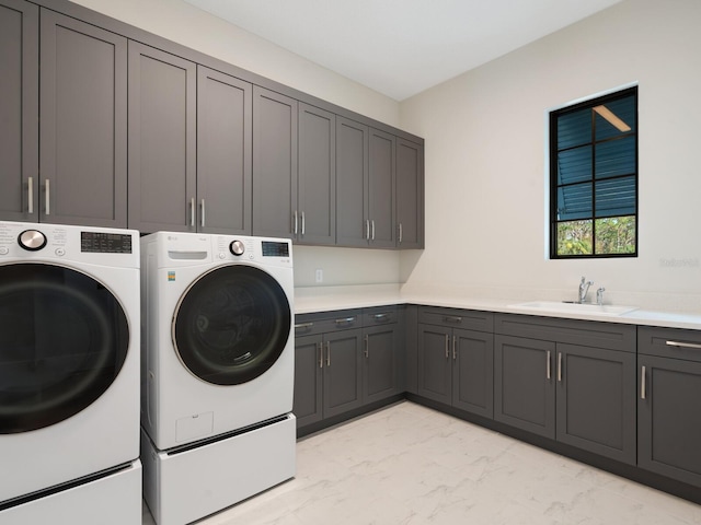1109 Bayshore Rd, Nokomis, FL 34275 - laundry room featuring cabinet space, independent washer and dryer, and light marble finish flooring