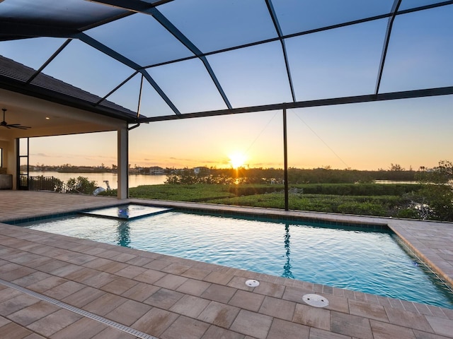 1109 Bayshore Rd, Nokomis, FL 34275 - pool at dusk with a water view, a patio area, an outdoor pool, and ceiling fan
