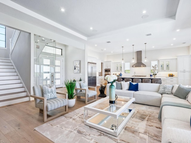 1109 Bayshore Rd, Nokomis, FL 34275 - living area featuring light wood-type flooring, recessed lighting, and stairs