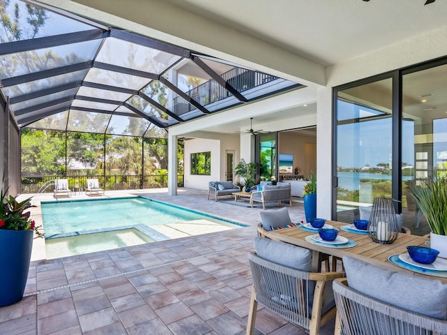 1109 Bayshore Rd, Nokomis, FL 34275 - view of swimming pool featuring a ceiling fan, outdoor lounge area, a patio, glass enclosure, and a pool with connected hot tub