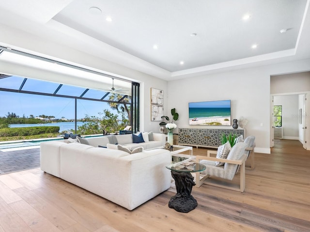1109 Bayshore Rd, Nokomis, FL 34275 - living room featuring a sunroom, a tray ceiling, wood finished floors, and recessed lighting