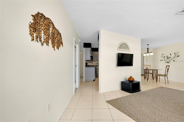 corridor featuring light tile patterned floors