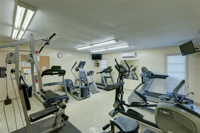 workout area with a textured ceiling and an AC wall unit