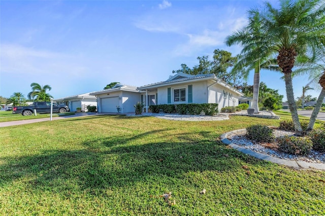 ranch-style house featuring a front lawn and a garage