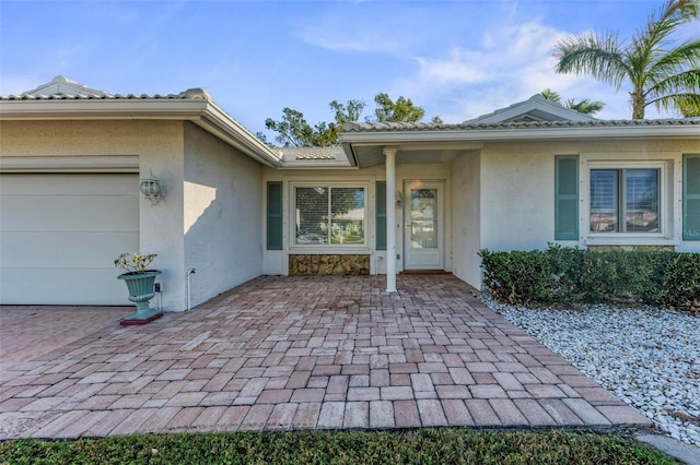 view of exterior entry featuring a garage