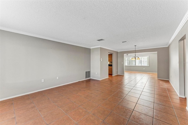 tiled empty room featuring ornamental molding, a chandelier, and a textured ceiling