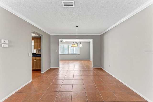 unfurnished dining area featuring ornamental molding, a notable chandelier, a textured ceiling, and tile patterned floors