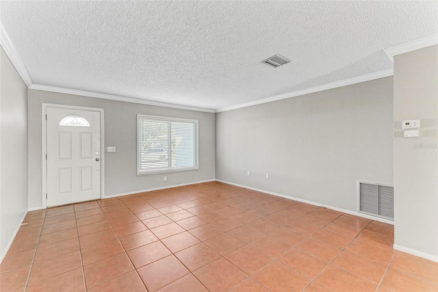 foyer with ornamental molding, a textured ceiling, and light tile patterned floors