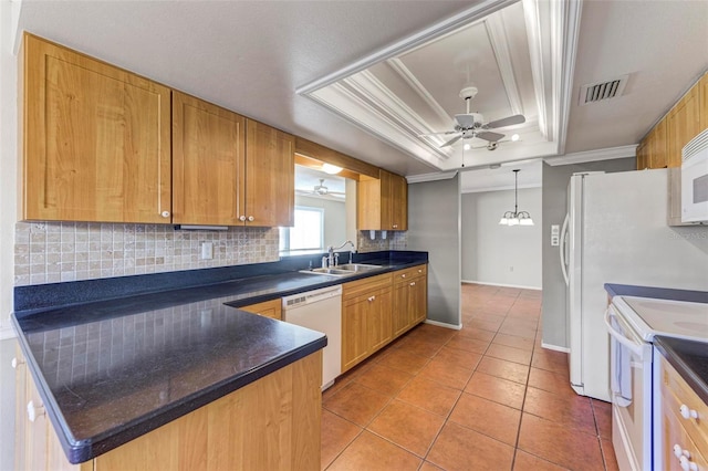 kitchen with white appliances, a tray ceiling, ornamental molding, sink, and ceiling fan with notable chandelier