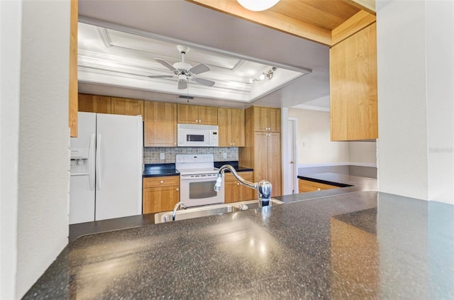 kitchen with ceiling fan, a raised ceiling, ornamental molding, sink, and white appliances