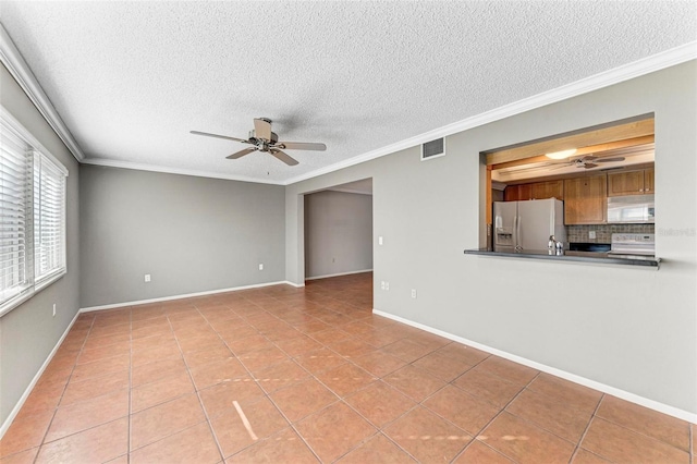 unfurnished living room with ceiling fan, a textured ceiling, ornamental molding, and light tile patterned floors