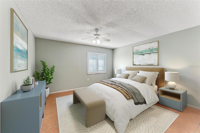 bedroom with tile patterned flooring, a textured ceiling, and ceiling fan