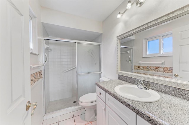 bathroom featuring vanity, tile patterned floors, toilet, and an enclosed shower