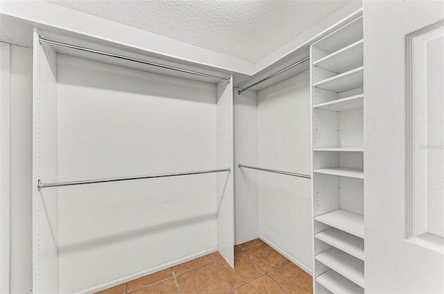 spacious closet with light tile patterned flooring