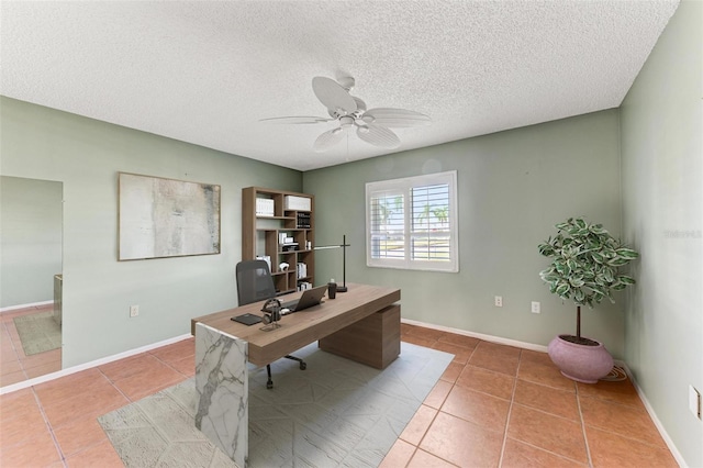 tiled office space featuring a textured ceiling and ceiling fan