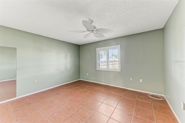 tiled spare room with a textured ceiling and ceiling fan