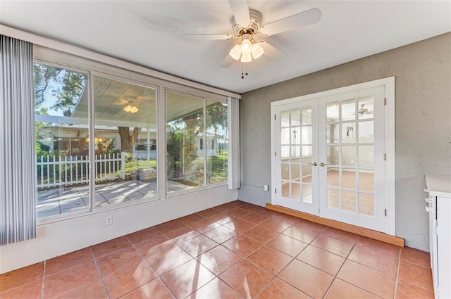 unfurnished sunroom featuring french doors and ceiling fan