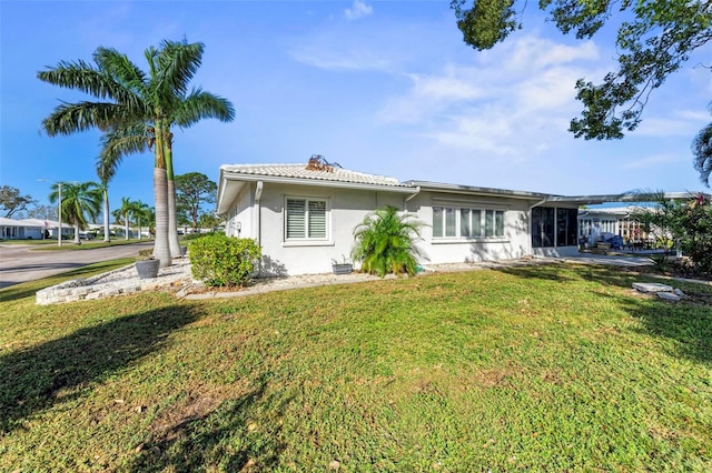 back of house with a lawn